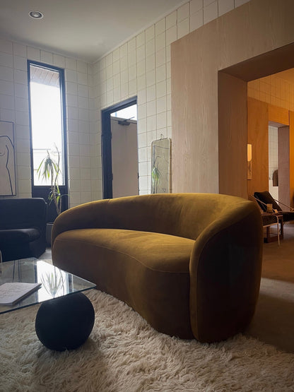 curved ochre sofa